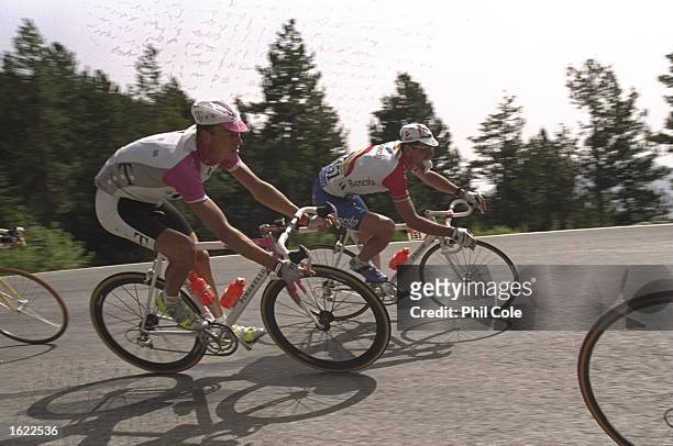 Bjarne Riis of Denmark and team Telekom ridees alongside Abraham Olano of Spain and team Banesto during stage 10 of the Tour de France from Luchon to...