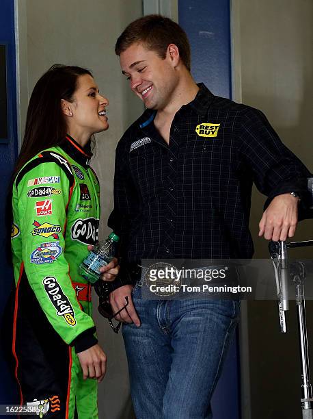 Danica Patrick, driver of the GoDaddy.com Chevrolet, talks with Cup Series Ricky Stenhouse Jr., driver of the Best Buy Ford, in the garage during...