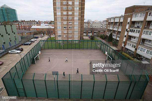 Children play a game of football in front of a residential development in the London borough of Tower Hamlets on February 21, 2013 in London,...