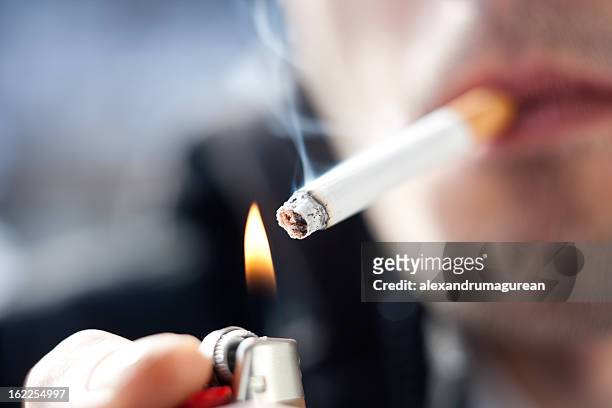 smoking cigarette - cigarette lighter stock pictures, royalty-free photos & images