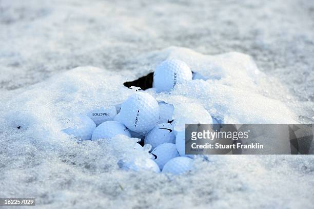 Pile of Nike practice balls is seen on the driving range as the start of the continuation of round one is delayed due to snow on the course during...
