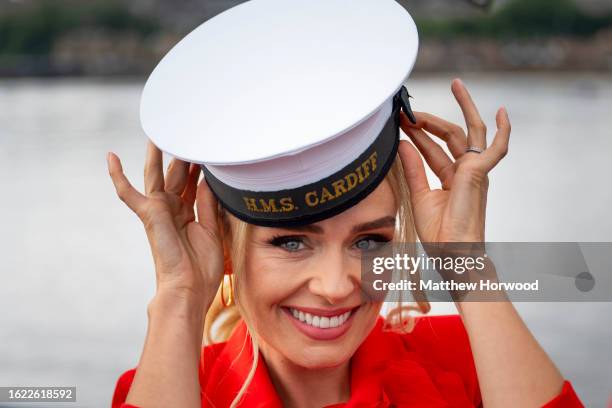 Katherine Jenkins poses for a photograph wearing a HMS Cardiff hat on HMS Express as she is named as the sponsor of HMS Cardiff on August 25, 2023 in...