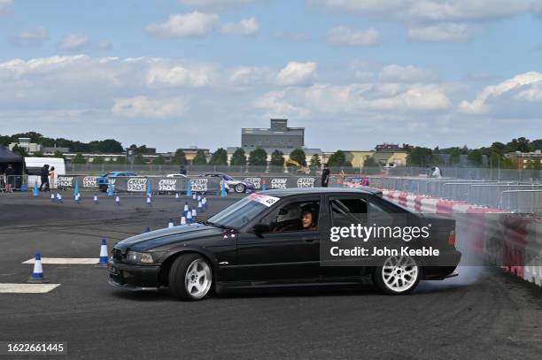 Visitors take a passenger ride with a drift expert in a real track ready drift car during the British Motor Show at Farnborough International...