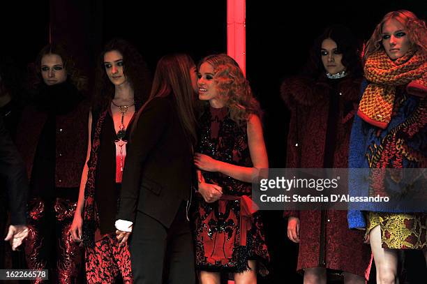 Designer Eva Cavalli is congratulated by model Georgia May Jagger and her other models as she acknowledges the applause of the audience after the...
