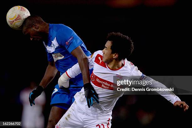 Khaleem Hyland of Genk heads the ball under the pressure of Shinji Okazaki of Stuttgart during the UEFA Europa League Round of 32 second leg match...