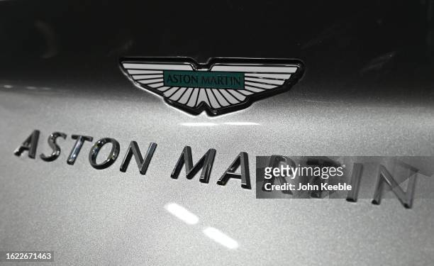 An Aston Martin logo badge on a DB12 is displayed during the British Motor Show at Farnborough International Exhibition Centre on August 17, 2023 in...