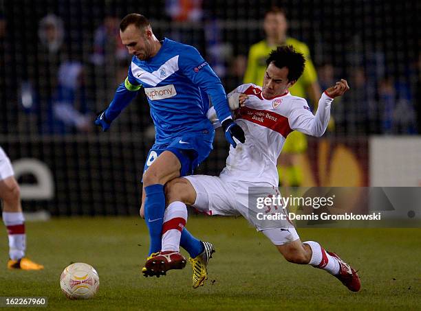 Thomas Buffel of Genk is challenged by Shinji Okazaki of Stuttgart during the UEFA Europa League Round of 32 second leg match between KRC Genk and...