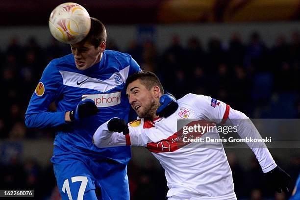 Jeroen Simaeys of Genk and Vedad Ibisevic of Stuttgart battle for the ball during the UEFA Europa League Round of 32 second leg match between KRC...