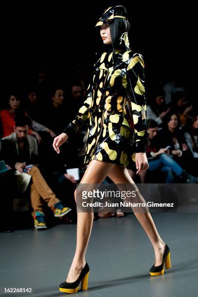 Model showcases designs by Maria Escote on the runway at the Maria Escote show during Mercedes Benz Fashion Week Madrid Fall/Winter 2013/14 at Ifema...