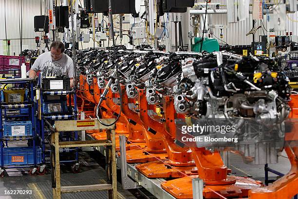 Employee Cliff McCloskey assembles an 2.0 liter ecoboost engines on the production line at the Ford Motor Co. Cleveland Engine Plant in Brook Park,...