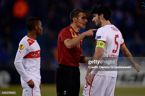 Referee Alon Yefet urges Serdar Tasci of Stuttgart during the UEFA Europa League Round of 32 second leg match between KRC Genk and VfB Suttgart at...