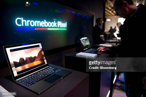 Attendees look at new Google Inc. Chromebook Pixel laptops during a launch event in San Francisco, California, U.S., on Thursday, Feb. 21, 2013....