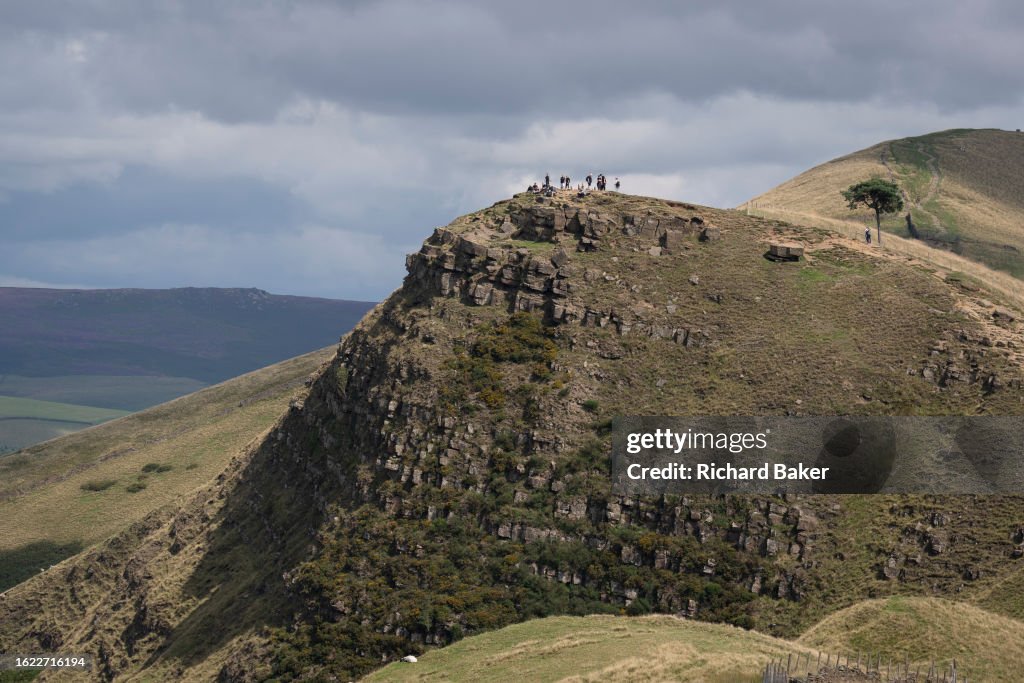Back Tor Path Family walkers and long-distance hikers stand on the top of Back Tor ...
