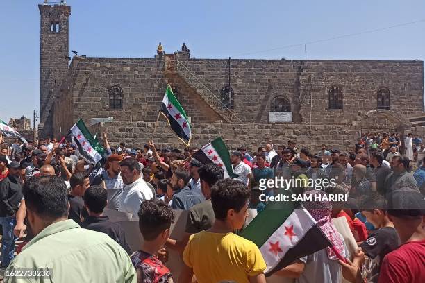 Syrians protest in the southern town of Busra on August 25, 2023 as dire living conditions stoke discontent in regime-held areas. Rare protests have...