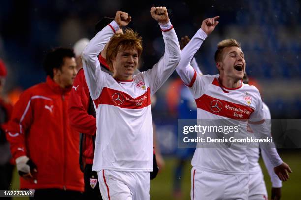 Gotoku Sakai of Stuttgart and teammate Alexandru Maxim celebrate after the UEFA Europa League Round of 32 second leg match between KRC Genk and VfB...