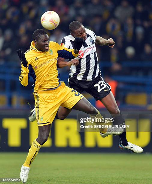 Metalist Kharkiv's Senegalese defender Papa Gueye fights for the ball with Newcastle United's Nigerian forward Shola Ameobi during their UEFA Europa...