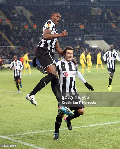 Shola Ameobi of Newcastle United celebrates with Yohan Cabaye after scoring from the penalty spot during the UEFA Europa League round of 32 second...