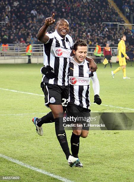 Shola Ameobi of Newcastle United celebrates with Yohan Cabaye after scoring from the penalty spot during the UEFA Europa League round of 32 second...