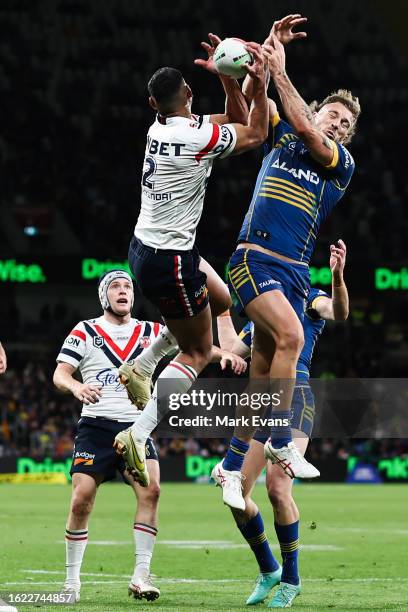 Daniel Tupou of the Roosters and Bryce Cartwright of the Eels jump for the ball during the round 25 NRL match between Parramatta Eels and Sydney...