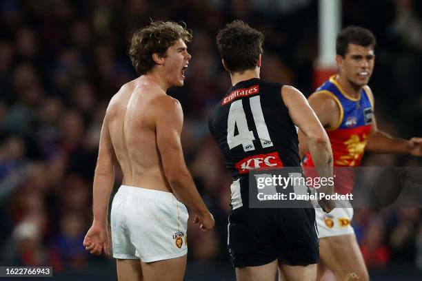 Deven Robertson of the Lions reacts after removing his torn guernsey during the round 23 AFL match between Collingwood Magpies and Brisbane Lions at...