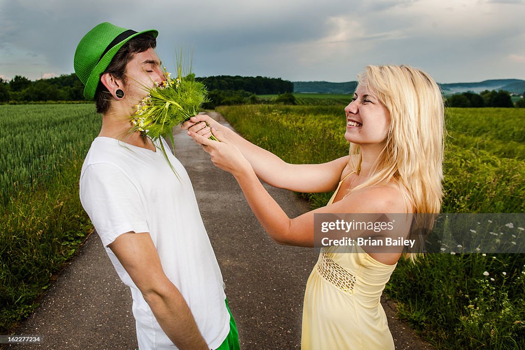 Playful young couple in rural landscape