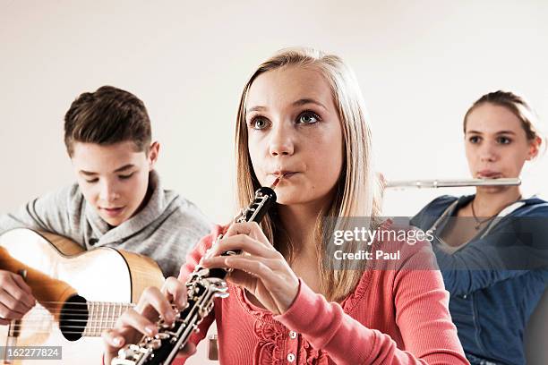 teenager playing music - flute traversiere photos et images de collection