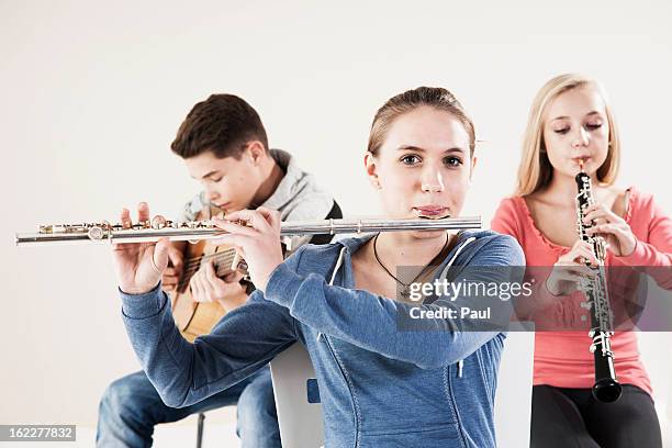 teenager playing music - flute traversiere photos et images de collection