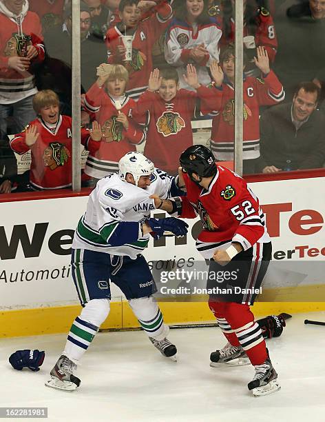 Children cheer as Brandon Bollig of the Chicago Blackhawks fights with Dale Weise of the Vancouver Canucks at the United Center on February 19, 2013...