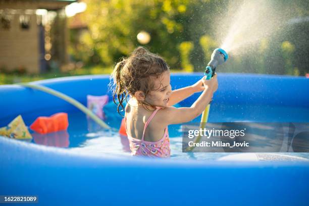 splashing all around - inflatable swimming pool stock pictures, royalty-free photos & images