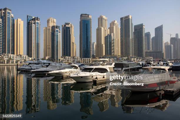 Residential skyscraper buildings beyond motor yachts docked in the Dubai Marina district of Dubai, United Arab Emirates, on Friday, Aug. 25, 2023....