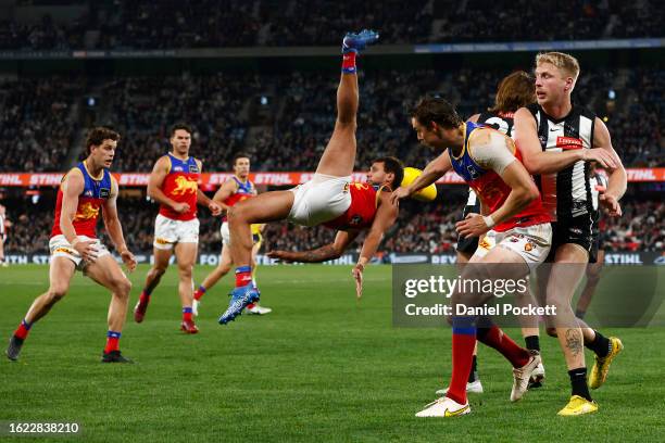 Callum Ah Chee of the Lions attempts to mark the ball over Nathan Murphy of the Magpies during the round 23 AFL match between Collingwood Magpies and...