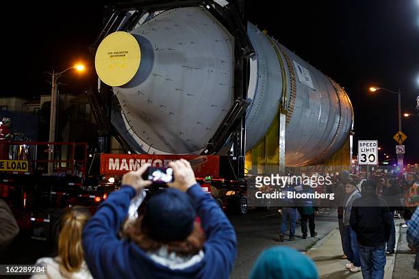 People take pictures of a steel coke drum on a trailer manufactured by Mammoet Salvage BV as it travels along the Pacific Coast Highway between...