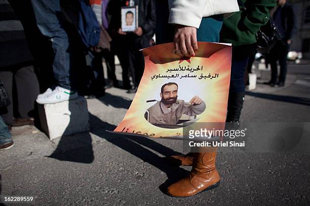 Supporter of Samer al-Issawi, a Palestinian prisoner on a hunger strike, holds a poster during a demonstration outside the Magistrate's Court on...