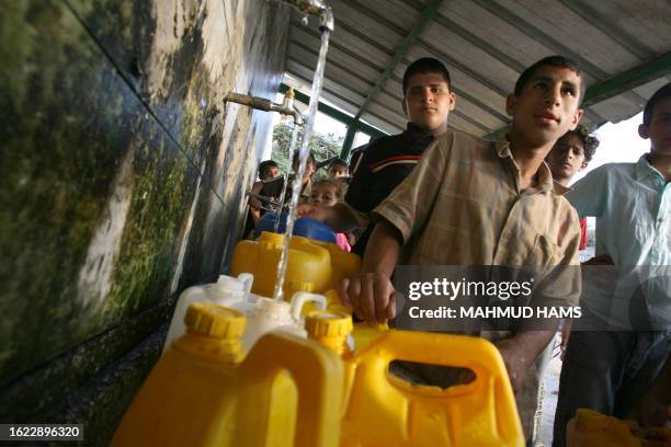 Palestinians fill up with clean water from stand-pipes in Khan Yunis in the southern Gaza Strip 04 September 2007. Israeli Deputy Prime Minister Haim...