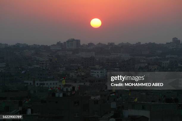 As the sun sets over Gaza City, the costal strip continues to stay in the dark while the power cuts continue, 20 August 2007. Gaza hummed with the...