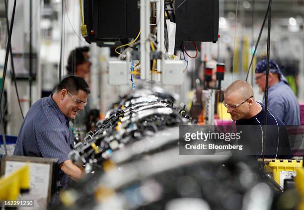Employees assemble 2.0 liter ecoboost engines on the production line at the Ford Motor Co. Cleveland Engine Plant in Brook Park, Ohio, U.S., on...