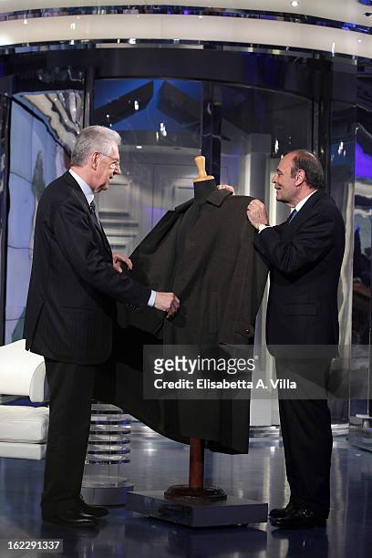 Italian Prime Minister Mario Monti and TV presenter Bruno Vespa look at a Loden coat during filming for the 'A Porta A Porta' TV Show on February 21,...