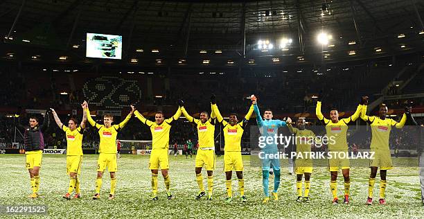 Anzhi Makhachkala's players celebrate after the UEFA Europa League Round of 32 football match Hannover 96 vs FC Anzhi Makhachkala in Hanover,...