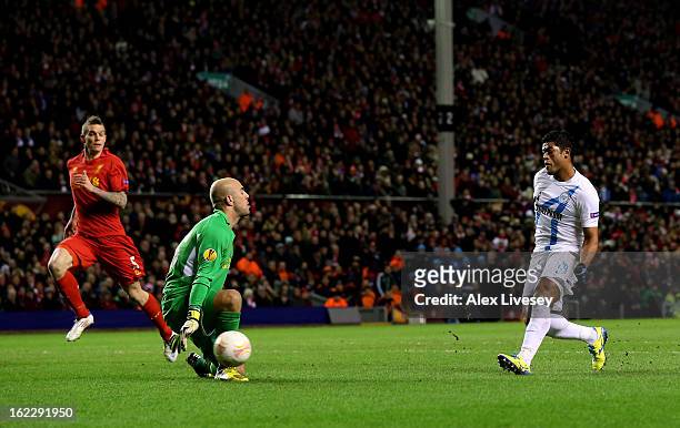 Hulk of Zenit scores the opening goal past goalkeeper Pepe Reina of Liverpool during the UEFA Europa League round of 32 second leg match between...
