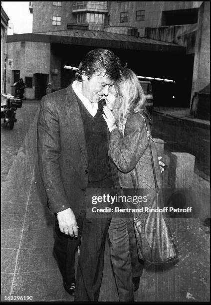 Alain Delon and his partner Catherine Pironi going to sculptor Paul Belmondo's exhibition.