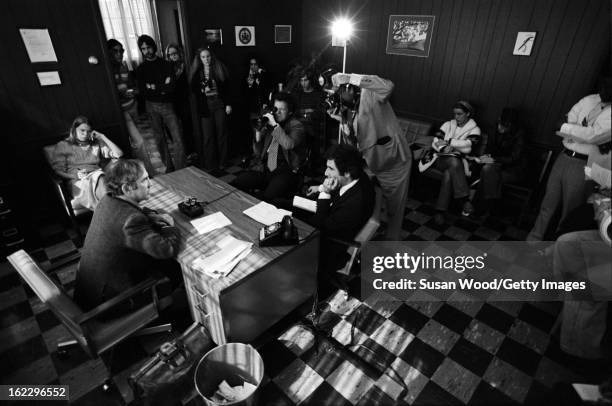 As students watch, American military analyst and political activist Daniel Ellsberg is interviewed and photographed in an office on the University of...