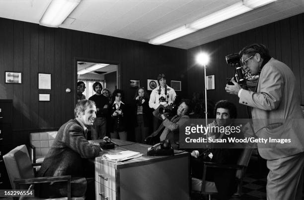 As students watch, American military analyst and political activist Daniel Ellsberg is interviewed and photographed in an office on the University of...