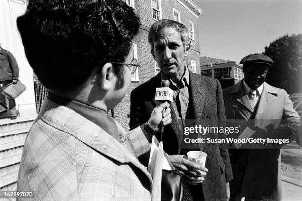 American military analyst and political activist Daniel Ellsberg is interviewed by a journalist from radio station FM98 outside a building on the...