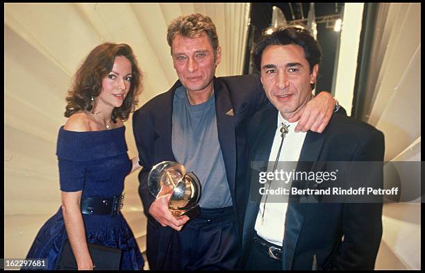 Gisele Galante, Johnny Hallyday and Richard Berry at the "Victoires de la Musique" French Music Awards Ceremony, 1987.