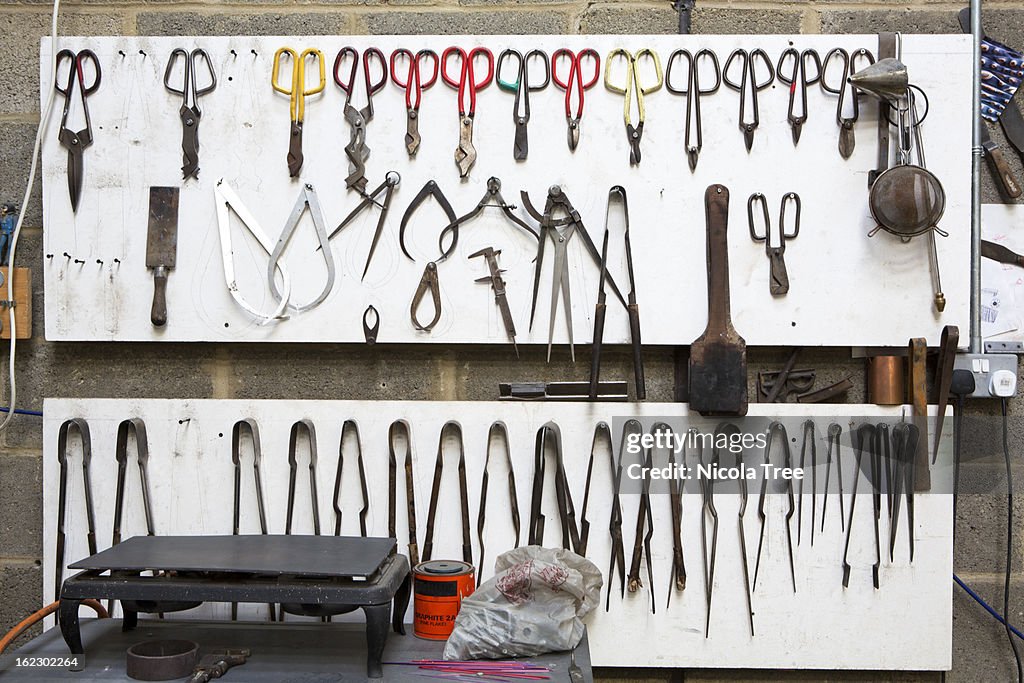 Glassblowing tools hung on the wall in order.