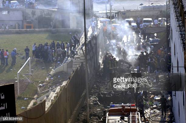 Lebanese army soldiers and civil defence workers secure the site where anti-Syrian MP Walid Eido, his eldest son and eight other people were killed...