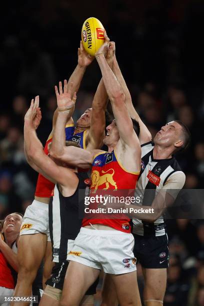 Darcy Cameron of the Magpies spoils Oscar McInerney of the Lions and Cam Rayner of the Lions during the round 23 AFL match between Collingwood...