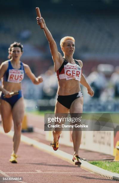 German athlete Grit Breuer raises her arm in triumph after winning the women's 4x400 metres event at the 2001 Athletics European Cup, held at the...