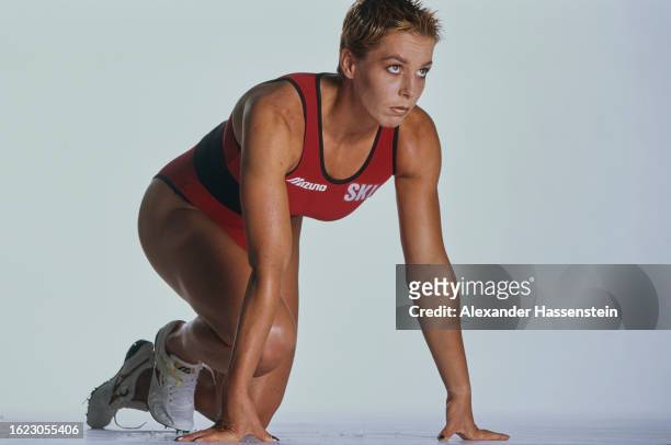 German athlete Grit Breuer adopts the starting pose during a studio portrait session, against a white background, July 1997. Formerly representing...