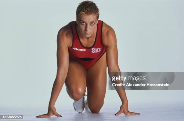 German athlete Grit Breuer adopts the starting pose during a studio portrait session, against a white background, July 1997. Formerly representing...
